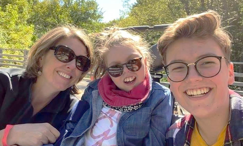 Three people smiling for the camera