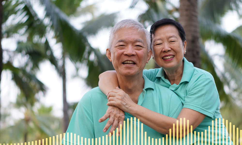 Asian elderly couple embracing each other smiling